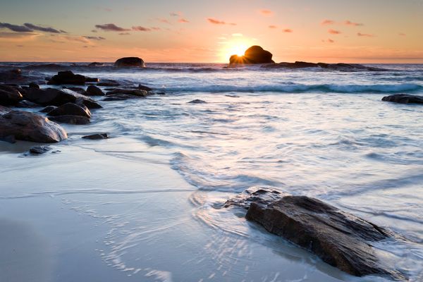 Sun setting over the horizon along the cape to cape trail